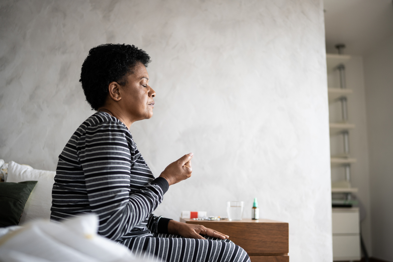 woman-taking-prescriptions-at-home-drug-addiction-concept